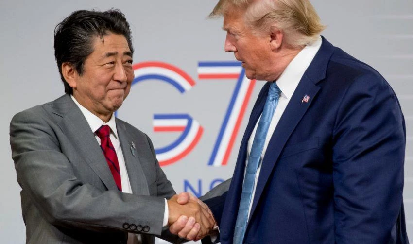 U.S President Donald Trump, right, and Japanese Prime Minister Shinzo Abe shake hands following a news conference at the Group of Seven summit in France. © AP