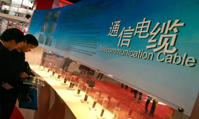 Visitors look at telecommunication cable displayed at an exhibition in Beijing, China on Oct. 24, 2007. (Teh Eng Koon/AFP/Getty Images)