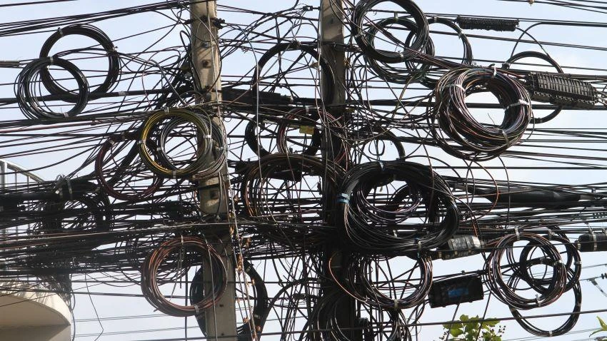 Cable TV, telephone and internet wiring all strung from the same concrete poles. (Photo by Ken Barrett)