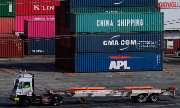 A truck passes by shipping containers at the Port of L.A., in Long Beach, Calif., on Sept. 1, 2019. (Mark Ralston/AFP/File Photo via Getty Images)