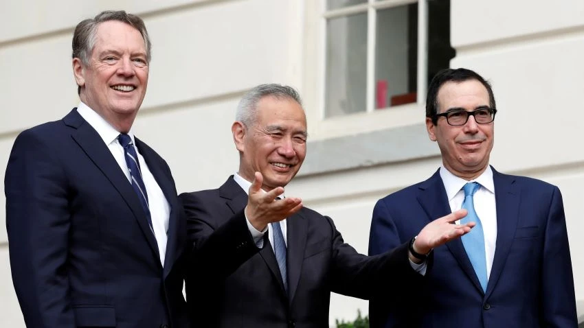 Chinese Vice Premier Liu He gestures to the media as he arrives Oct. 10 for trade talks with U.S. Trade Representative Robert Lighthizer, left, and Treasury Secretary Steve Mnuchin in Washington. © Reuters