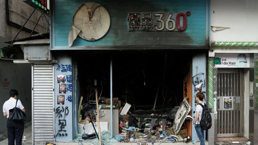 A man gazes at a Best Mart store that was vandalized during Hong Kong protests in October. © Reuters
