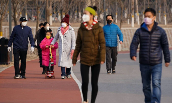 People wearing masks walk at a park in Beijing on Feb. 29, 2020. (Lintao Zhang/Getty Images)