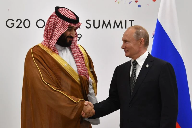 Vladimir Putin, right, shakes hands with Mohammed bin Salman on the sidelines of the G20 Summit in Osaka in 2019.Photographer: Yuri Kadobnov/AFP via Getty Images