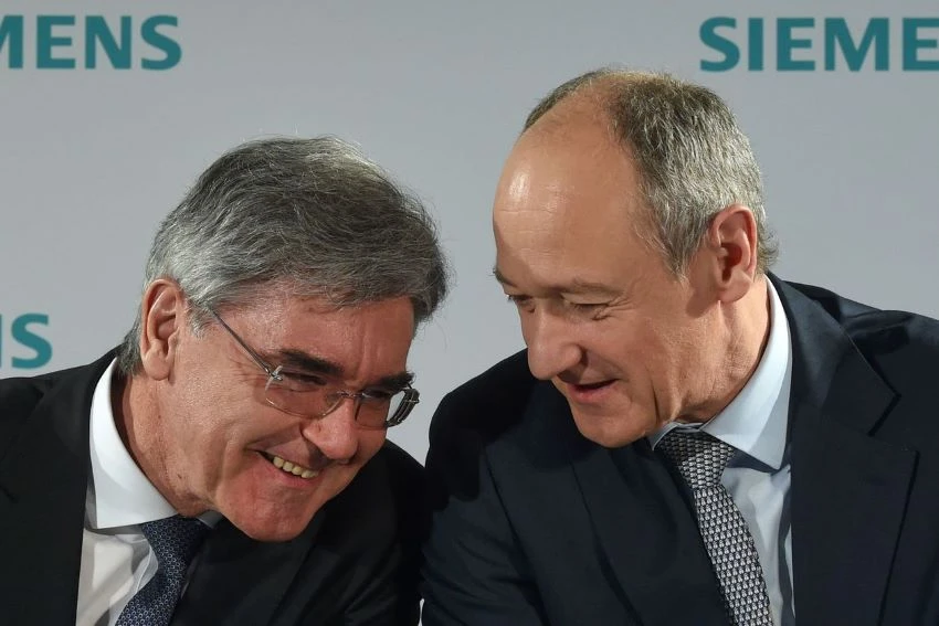 The leadership transition will be gradual, the company said, with Deputy CEO Roland Busch, right, taking on more responsibilities from CEO Joe Kaeser, left. PHOTO: CHRISTOF STACHE/AGENCE FRANCE-PRESSE/GETTY IMAGES
