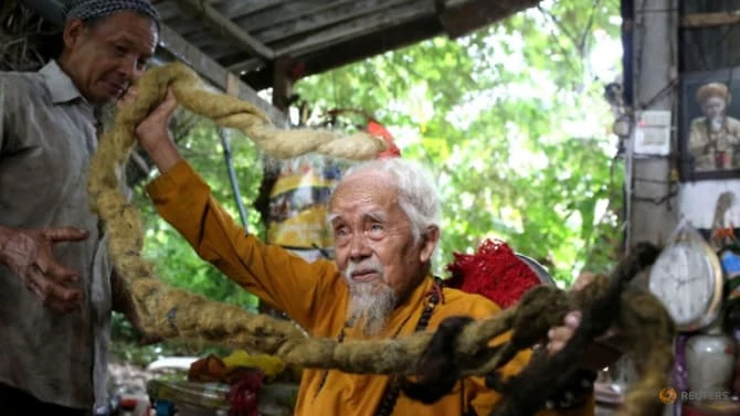 Nguyen Van Chien, 92, sits for a portrait to show his 5m long hair, which he said has not been cut for nearly 70 years, at his home in Tien Giang province, Vietnam, on Aug 21, 2020. (Photo: REUTERS/Yen Doung)