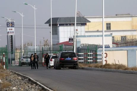 In this December 3, 2018, file photo, people walk by a police station by the front gate of the Artux City Vocational Skills Education Training Service Center in Artux in western China’s Xinjiang region. Credit: AP Photo/Ng Han Guan, File