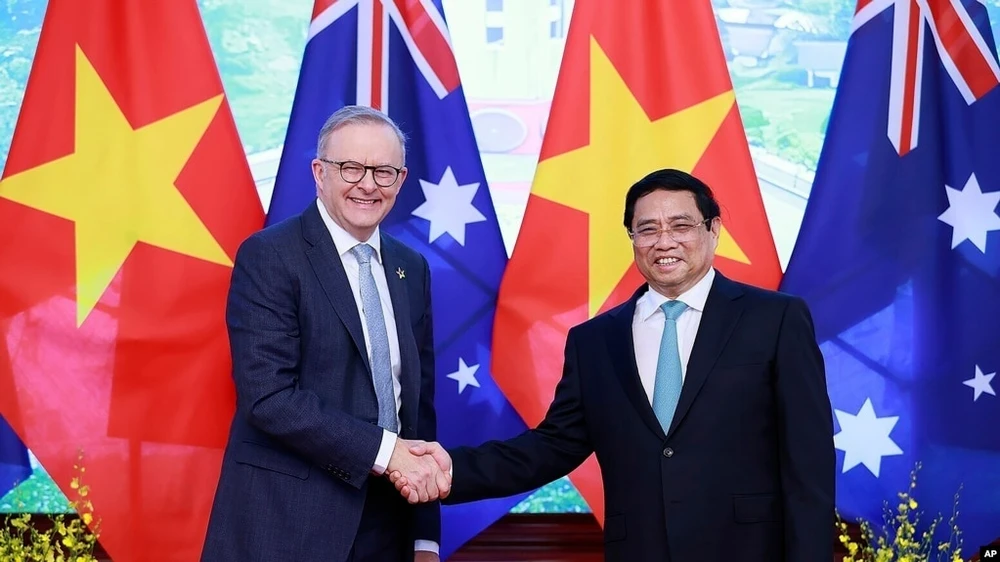 Australian Prime Minister Anthony Albanese, left, and Vietnamese Prime Minister Pham Minh Chinh, left, shake hands, ahead of their bilateral meeting in Hanoi, Vietnam, June 4, 2023. 