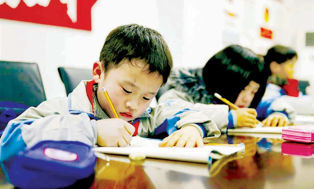 Học sinh tiểu học tại tỉnh Quý Châu, Trung Quốc làm bài tập sau giờ học