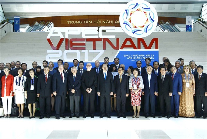 President Trần Đại Quang (eighth from the right) poses for a photo with delegates attending the Multi-Stakeholder Dialogue on APEC Toward 2020 and Beyond yesterday in Hà Nội. – VNA/VNS Photo An Đăng