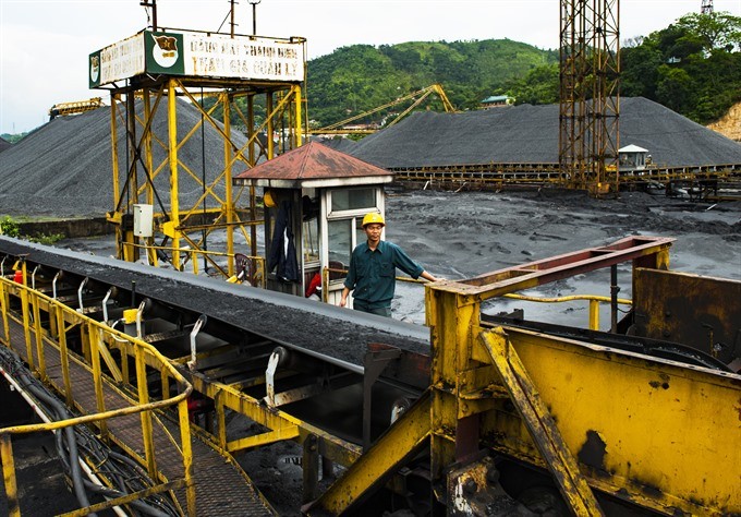 A worker of the Vietnam National Coal and Mineral Industries Group’ controls a production line. — VNA/VNS Photo Minh Duc