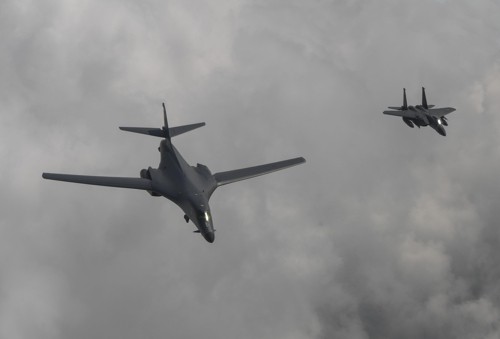 A U.S. B-1B bomber (L) flies over Korea along with a South Korean F-15K fighter on July 30, 2017, in this photo provided by the Air Force. (Yonhap)