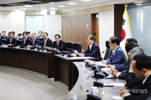 This file photo released by Cheong Wa Dae on July 29, 2017, shows President Moon Jae-in (C) presiding over an emergency meeting of the National Security Council. (Yonhap)