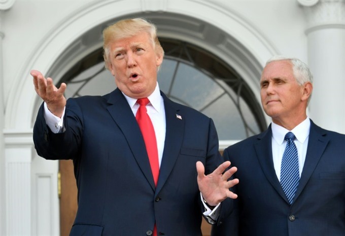 US President Donald Trump, with Vice President Mike Pence to his right, has more tough words for North Korea. — AFP/VNA
