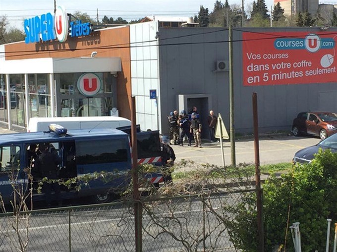 Police are seen at the scene of a hostage situation in a supermarket in Trebes, Aude, France on Friday in this picture obtained from a social media video. — REUTERS