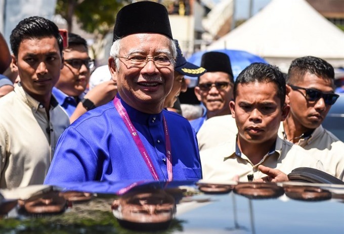 Malaysia’s Prime Minister Najib Razak smiles as he leaves after submitting his documents at the nomination centre in Pekan on April 28, 2018. Malaysia’s 14th general election is held on May 9 with nominations taking place on April 28. — AFP/VNA Photo