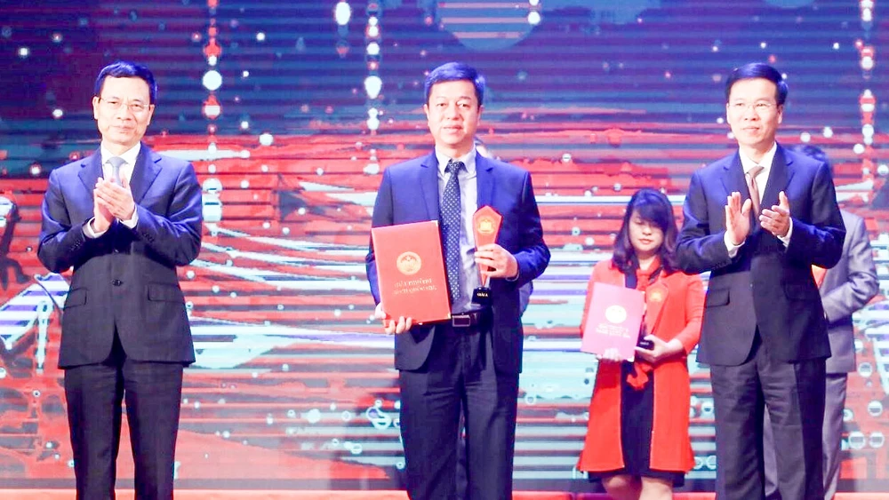 Đồng chí Võ Văn Thưởng và Bộ trưởng Bộ TT-TT Nguyễn Mạnh Hùng trao giải A cho các tác giả đoạt giải. Ảnh: TTXVN