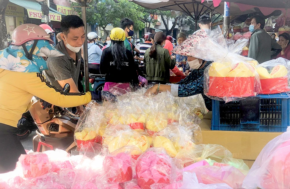 Khách mua đồ vía Thần Tài trưa 20-2 tại chợ Thiếc (quận 11, TPHCM). Ảnh: THI HỒNG