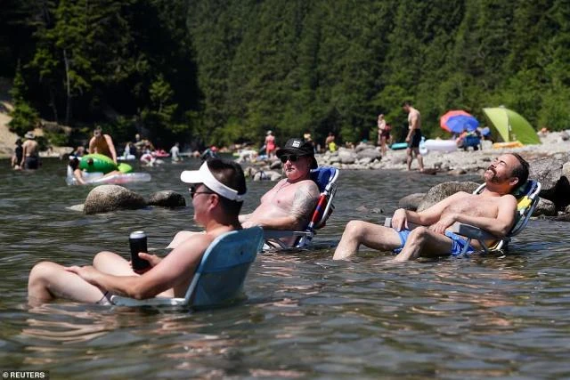 Người dân Maple Ridge, bang Bristish Columbia, Canada ngồi ngâm mình dưới nước biển. Ảnh: REUTERS