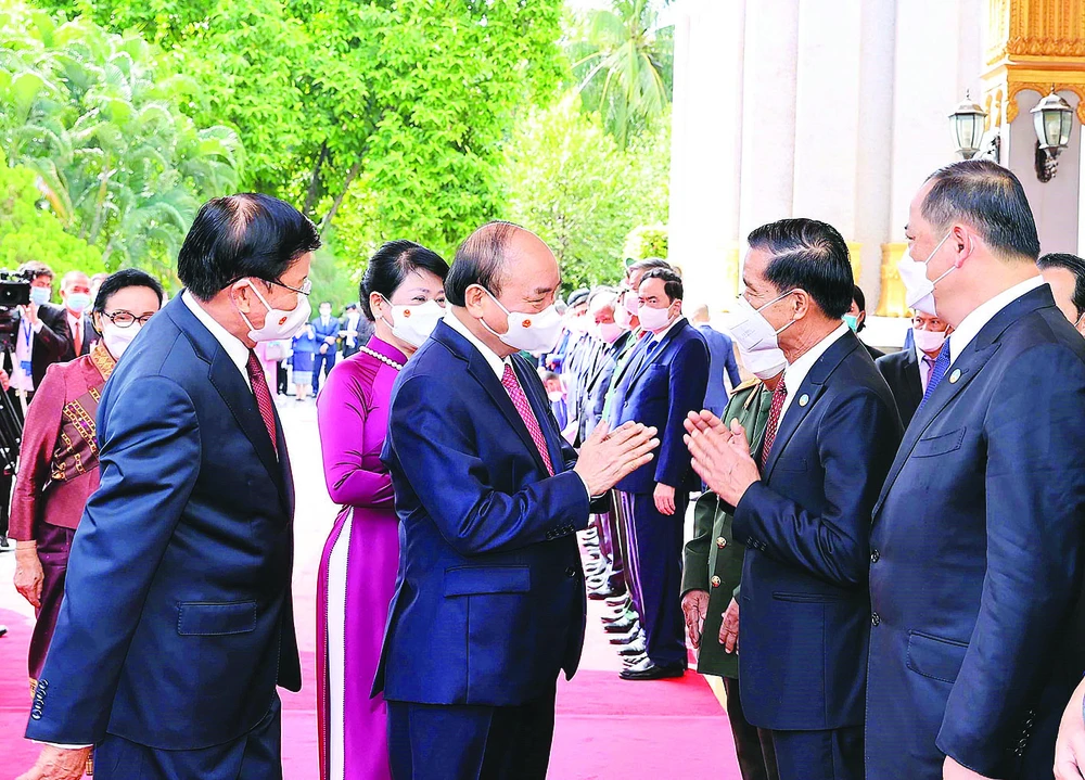 Chủ tịch nước Nguyễn Xuân Phúc và Tổng Bí thư, Chủ tịch nước Lào Thongloun Sisoulith với các thành viên đoàn đại biểu cấp cao 2 nước tại lễ đón. Ảnh: TTXVN