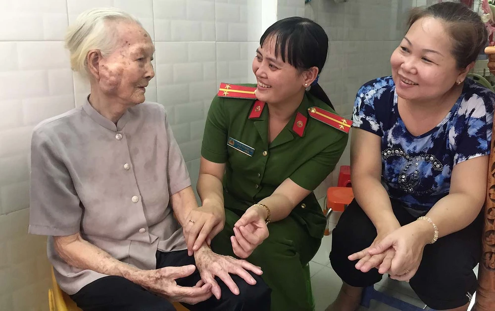 Nụ cười thân thiện của nữ trung úy Hoàng Yến (giữa) giúp lan tỏa chân tình của người chiến sĩ công an đến người dân