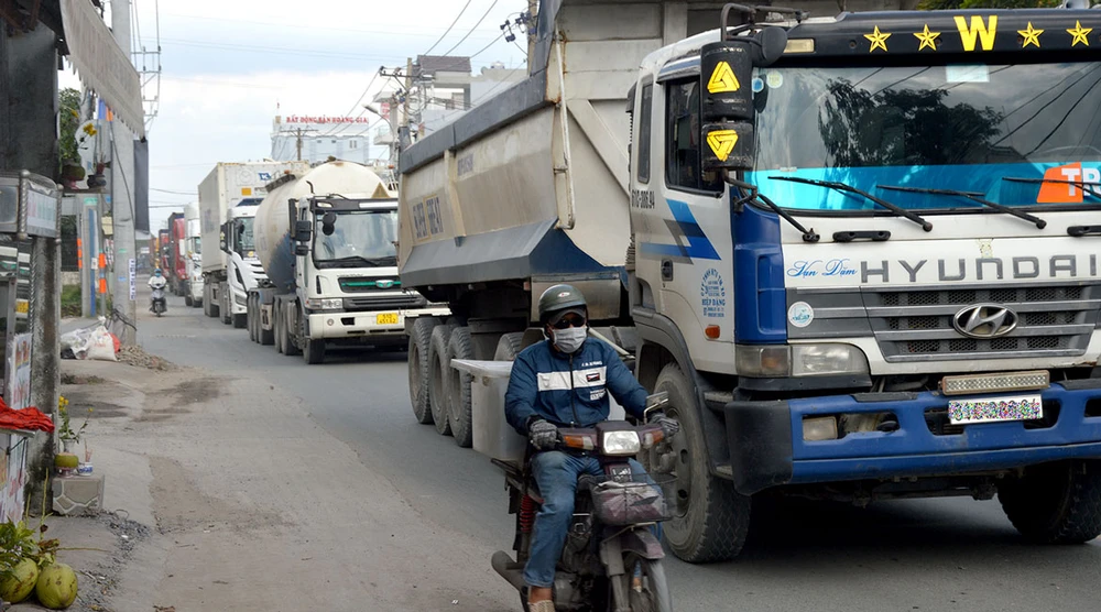 Người đi đường đối mặt hiểm nguy khi xe tải, container lưu thông ken dày trên đường Nguyễn Duy Trinh.