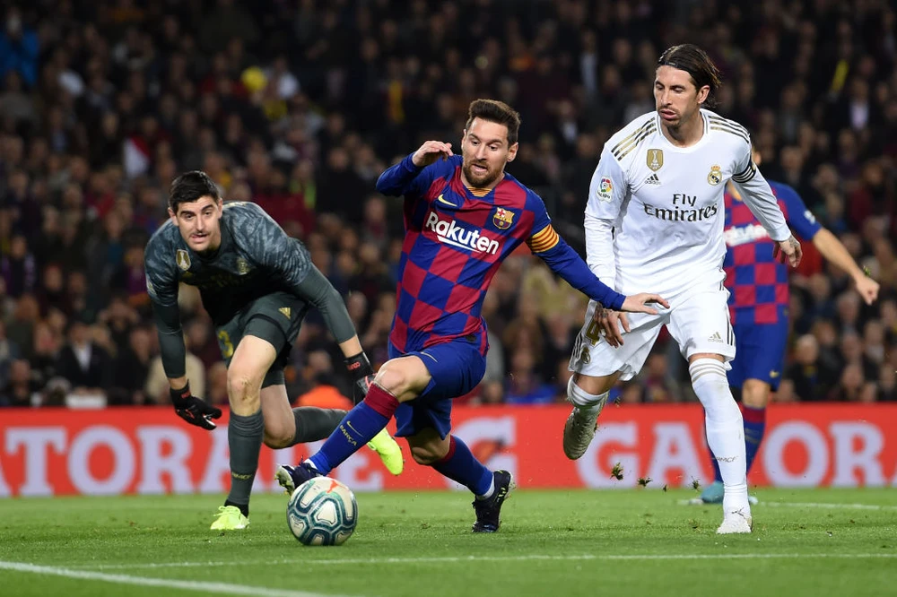 Lionel Messi tranh bóng với Sergio Ramos và thủ thành Thibaut Courtois