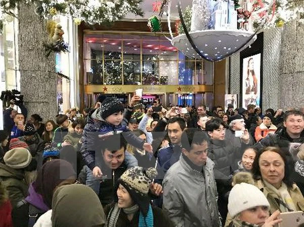Khách hàng xếp hàng chờ mua sắm bên ngoài cửa hiệu Macys tại New York, Mỹ ngày 23/11. (Ảnh: Kyodo/TTXVN)