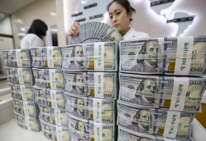 Kiểm tiền USD tại ngân hàng Hana ở thủ đô Seoul, Hàn Quốc. (Ảnh: EPA-EFE/TTXVN)