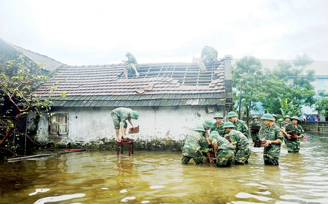 Bộ đội Biên phòng Hà Tĩnh giúp người dân ở xã Xuân Phổ lợp lại mái nhà