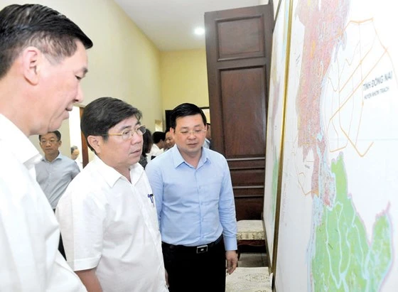 Chủ tịch UBND TPHCM Nguyễn Thành Phong xem bản đồ kế hoạch sử dụng đất kỳ cuối (2016 - 2020) của TPHCM. Ảnh: CAO THĂNG