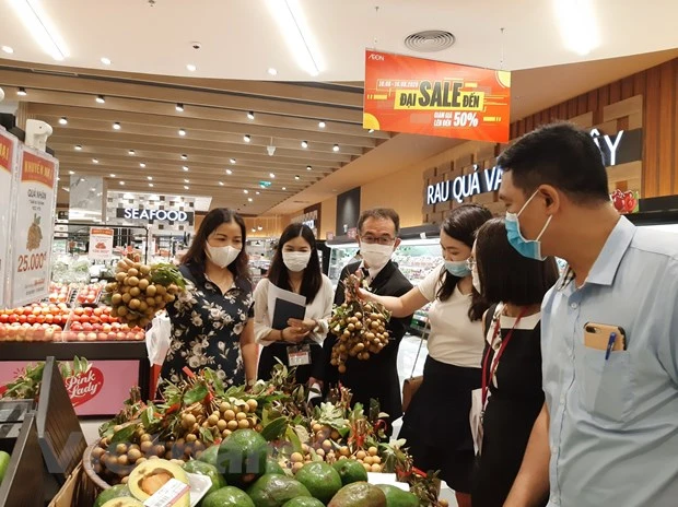 Bà Trần Thị Phương Lan kiểm tra việc cung ứng hàng hóa tại siêu thị. (Ảnh: PV/Vietnam+)