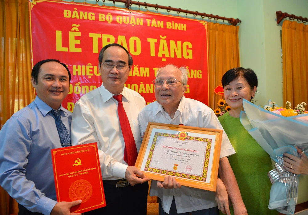 Bí thư Thành ủy TPHCM Nguyễn Thiện Nhân trao Huy hiệu 75 năm tuổi Đảng cho đồng chí Hoàng Dũng. Ảnh: VIỆT DŨNG