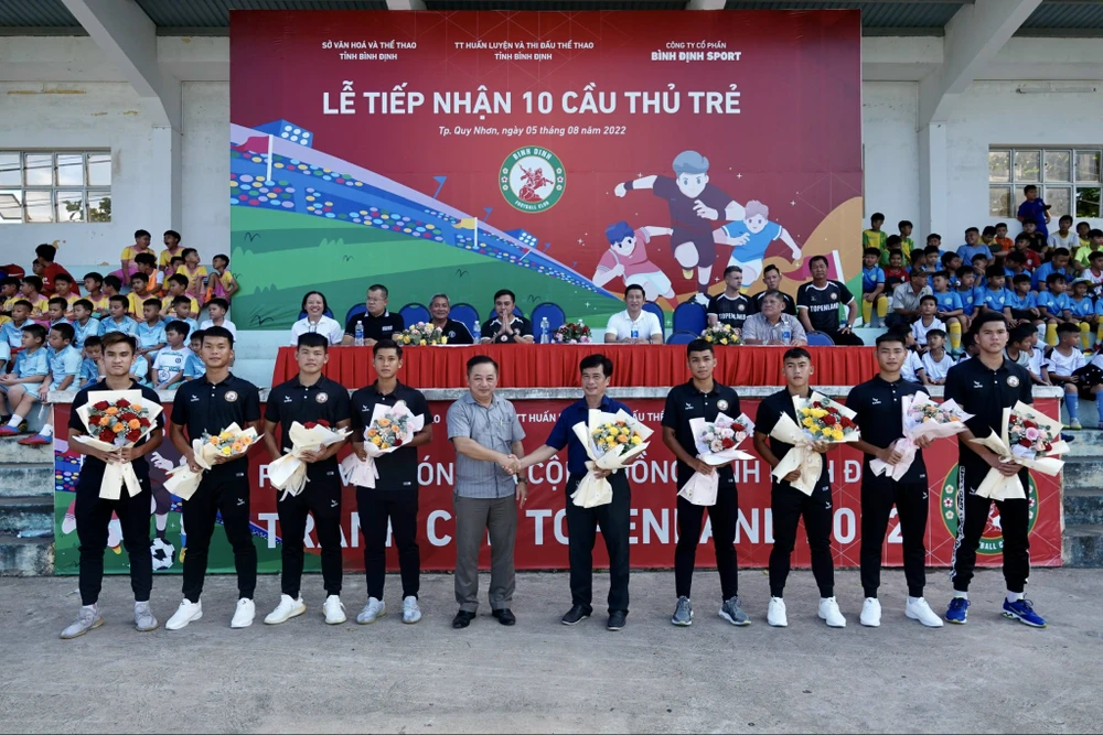 Lãnh đạo công ty Bình Định Sport trao hoa chúc mừng 10 cầu thủ trẻ chính thức gia nhập đội Topenland Bình Định. Ảnh: DŨNG PHƯƠNG