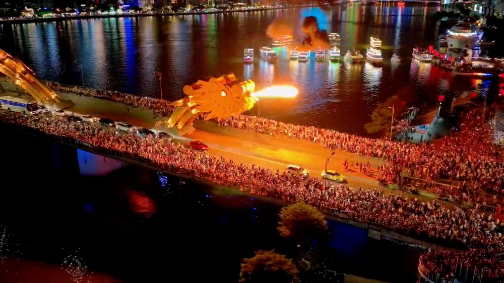 Đông đảo du khách đến thưởng thức màn trình diễn phun lửa phun nước của cầu Rồng. Ảnh: XUÂN QUỲNH