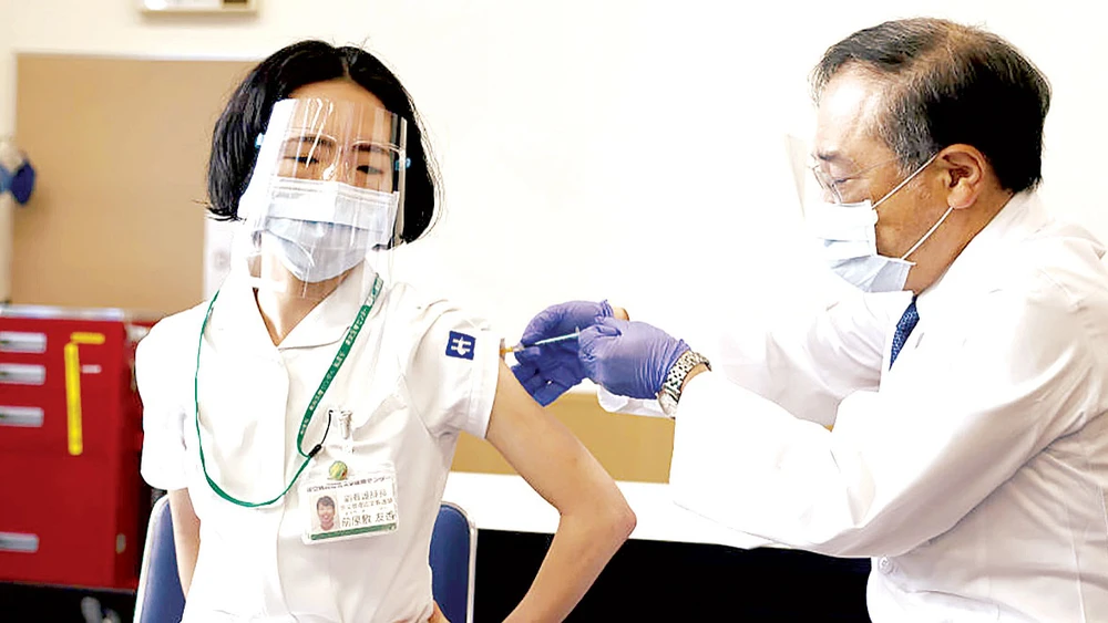 Nhân viên y tế Nhật Bản tiêm chủng vaccine ngừa Covid-19. Ảnh: Getty Images
