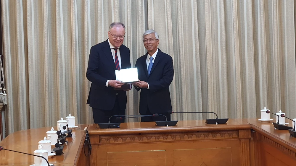 Phó Chủ tịch UBND TPHCM Võ Văn Hoan trao quà lưu niệm cho Thủ hiến bang Sachsen Stephan Weil. Ảnh: THỤY VŨ