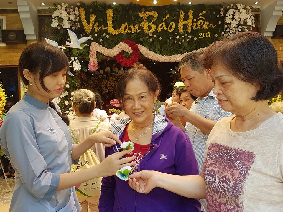 Nghi thức cài hoa hồng trong lễ Vu lan tổ chức tại chùa Minh Đạo (quận 3). Ảnh: HOÀI NAM
