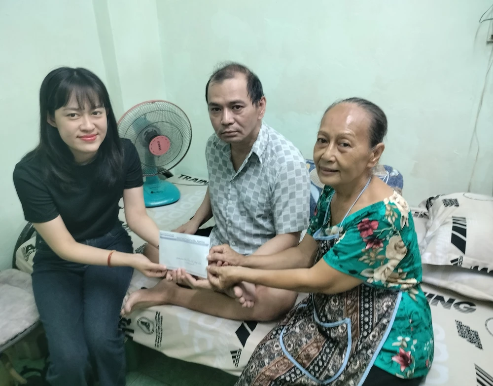 PV Báo SGGP trao tiền của bạn đọc giúp hoàn cảnh của cựu VĐV Ngọc Bảo. Ảnh: THANH TÙNG 
