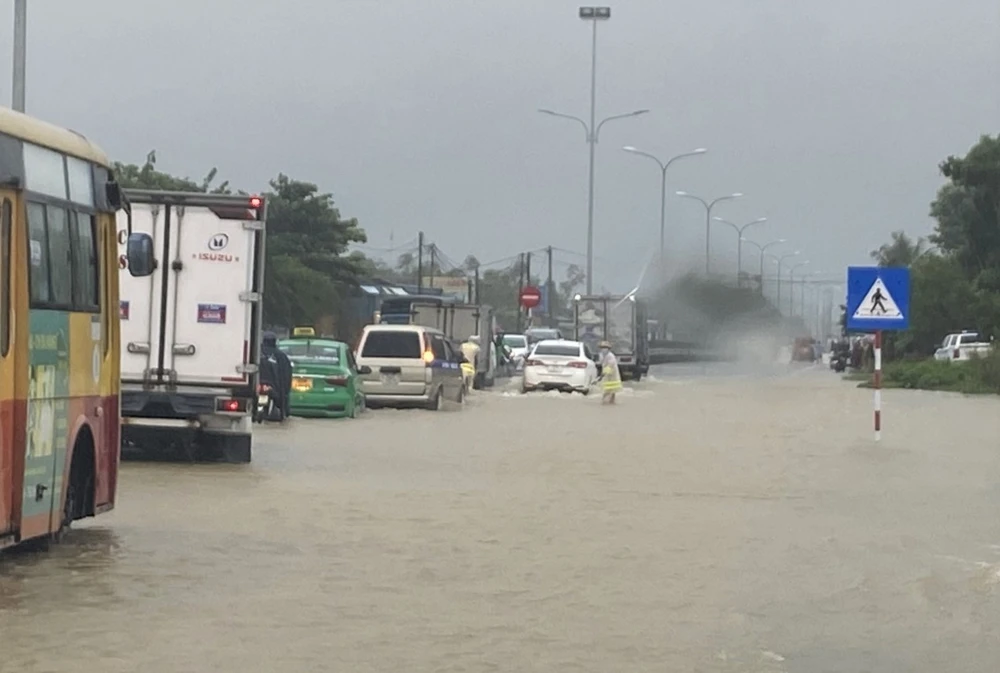 Nước ngập sâu một đoạn gần 100m trên tuyến Quốc lộ 1A tại huyện Phú Ninh (tỉnh Quảng Nam) khiến giao thông gặp khó khăn. Ảnh: NGUYỄN CƯỜNG