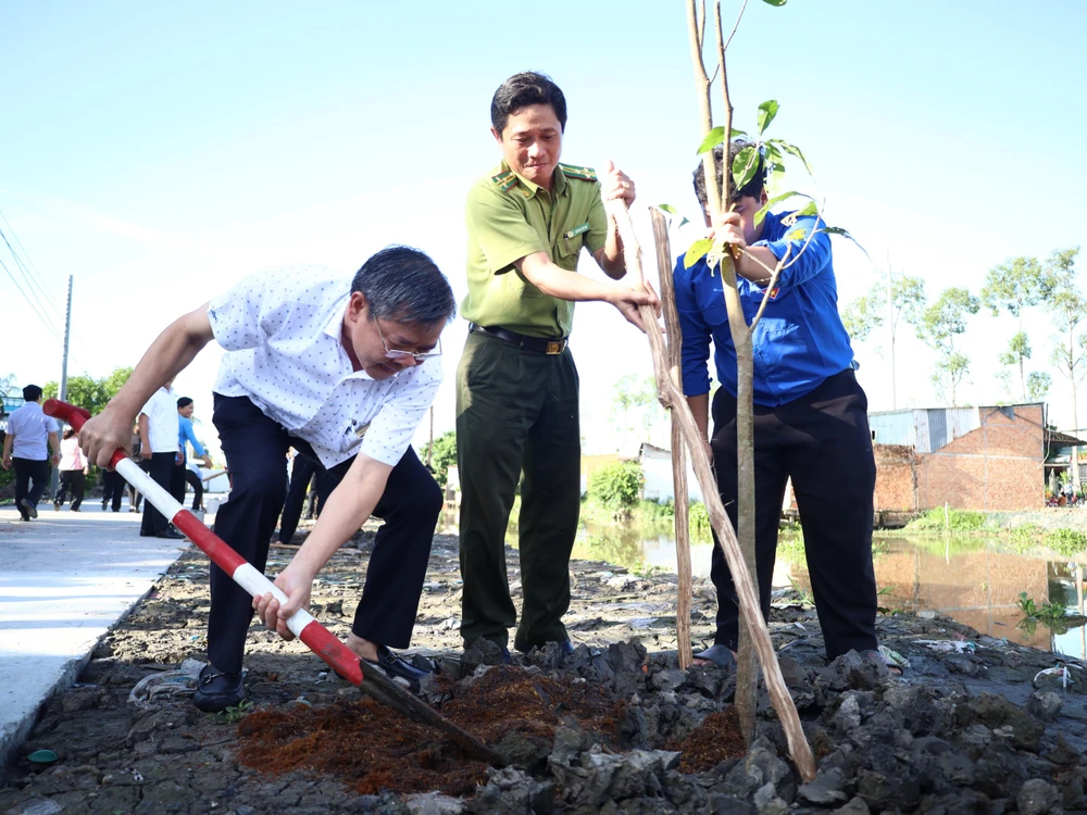 Ông Trương Cảnh Tuyên, Phó Chủ tịch Thường trực UBND tỉnh Hậu Giang (bìa trái) tham gia trồng cây sáng 6-7