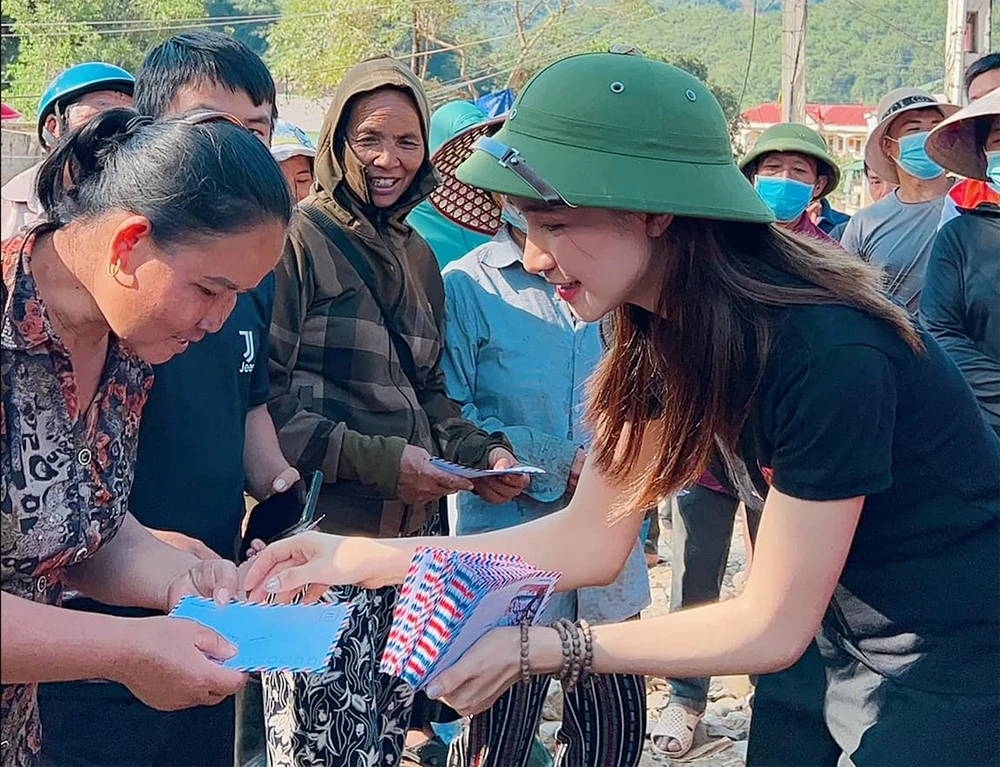 Ca sĩ Hòa Minzy trao tiền hỗ trợ đến người dân Nghệ An. Ảnh: FBNS