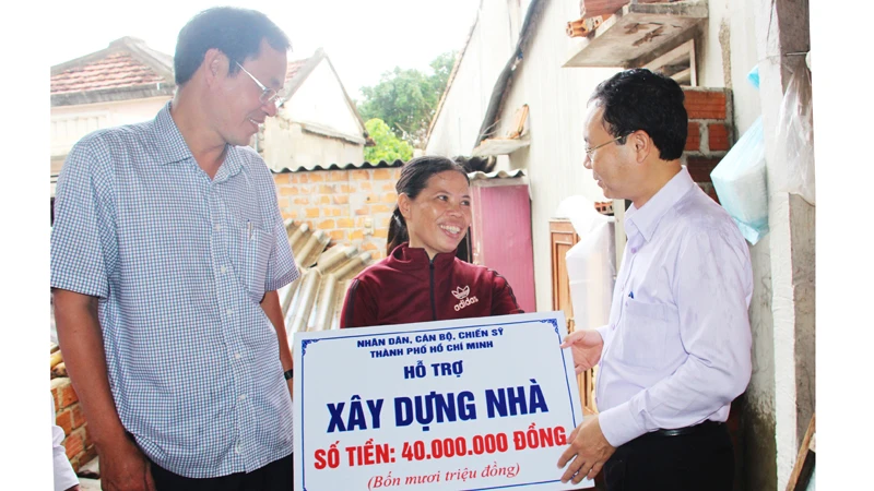Đồng chí Nguyễn Văn Hiếu trao tiền hỗ trợ xây nhà cho chị Hồ Thị Bông, ở xã Phước Sơn (huyện Tuy Phước, Bình Định)