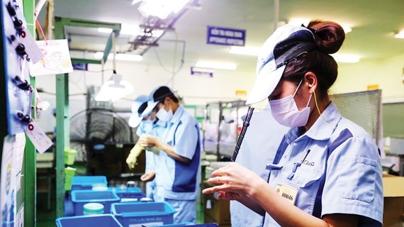 Workers at a Japanese firm in Vietnam (Photo: SGGP)