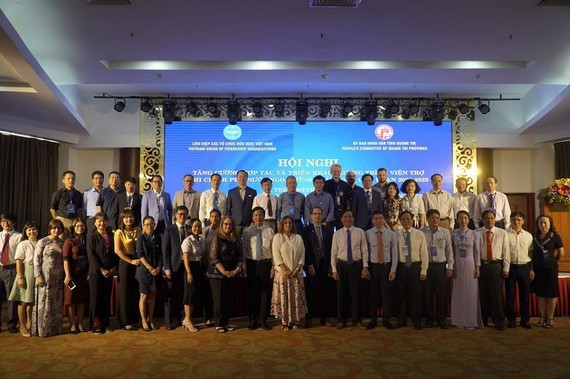 Participants in the conference to strengthen cooperation and implementation of the foreign non-governmental organization (NGO) aid program in Quang Tri province take a commemorative photo. (Photo: SGGP)