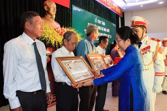18 women are posthumously presented with the Vietnamese Heroic Mother title in HCM City on December 11 (Photo: VNA)