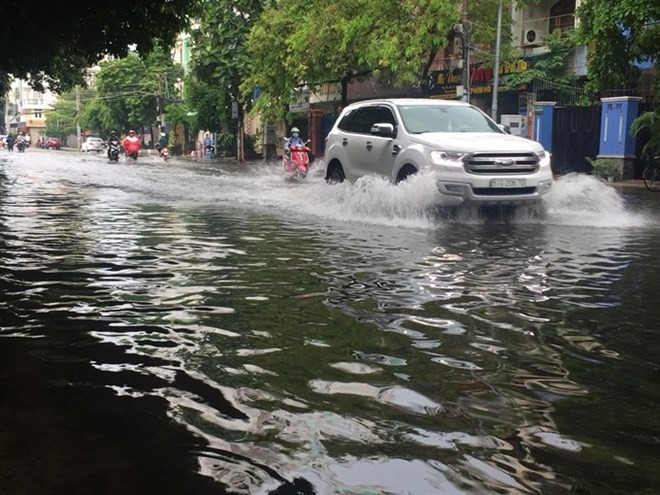 Heavy rains cause flooding on Thanh Loan Road in District 8, HCM City on May 20. (Photo: VNA)