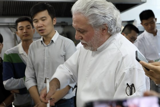  Two-star Michelin chef Alain Dutournier conducts a cooking class in KOTO vocational training center. 