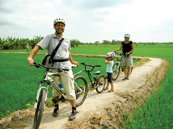 Foreign tourists visit the Mekong Delta region.