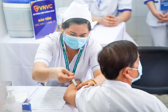 Healthcare workers of the HCMC Hospital for Tropical Diseases get the AstraZeneca’s Covid-19 jab on March 8.